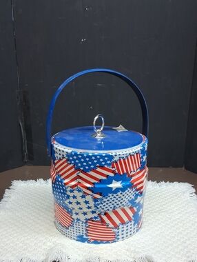 Patriotic Mr. Ice Bucket features a vibrant USA flag pattern& sturdy blue handle
